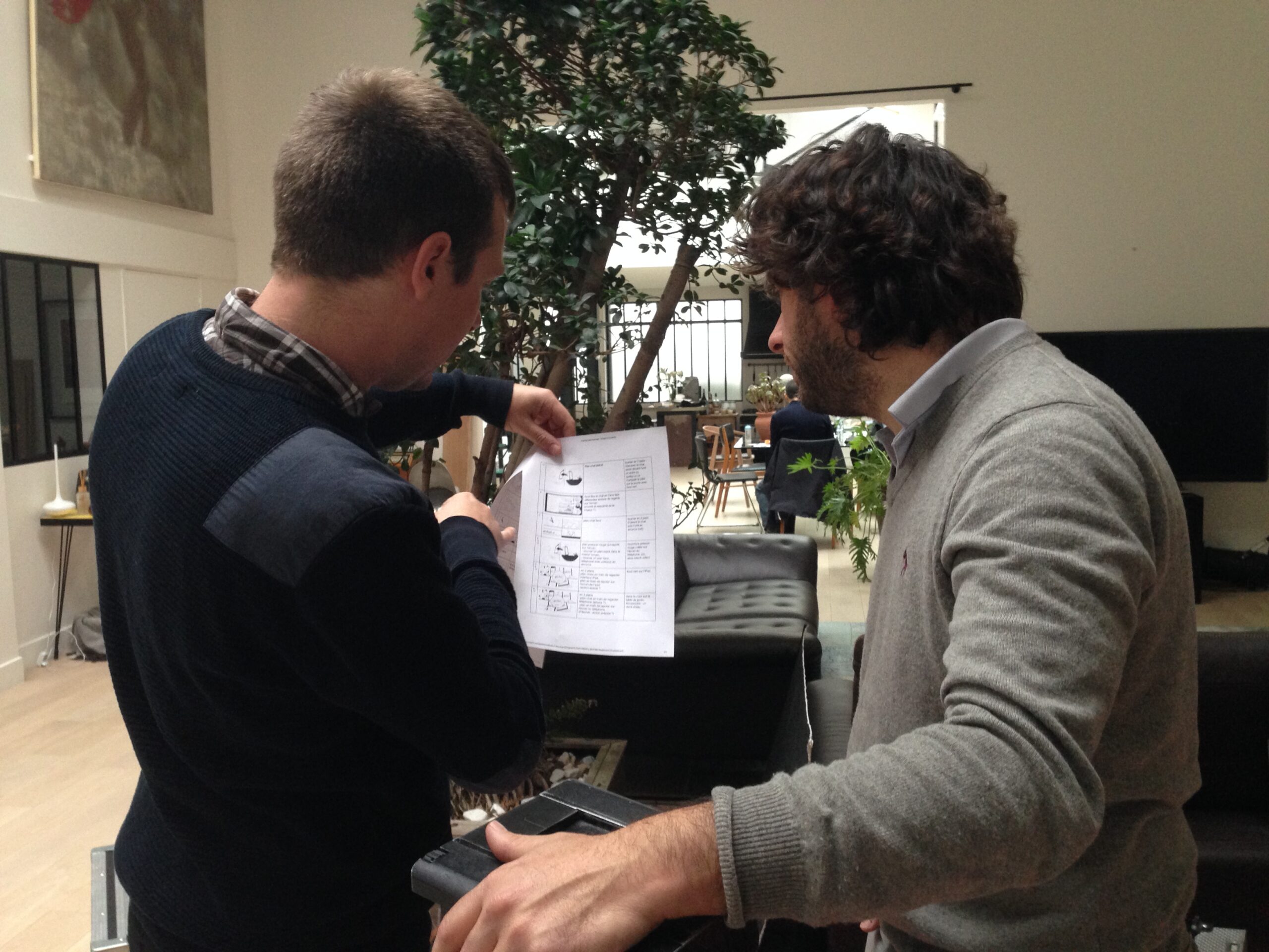 Two crew members discuss a printed storyboard in the loft used for the shoot.