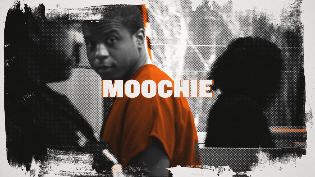 Moochie turns towards the camera as the title appears over his orange shirt.