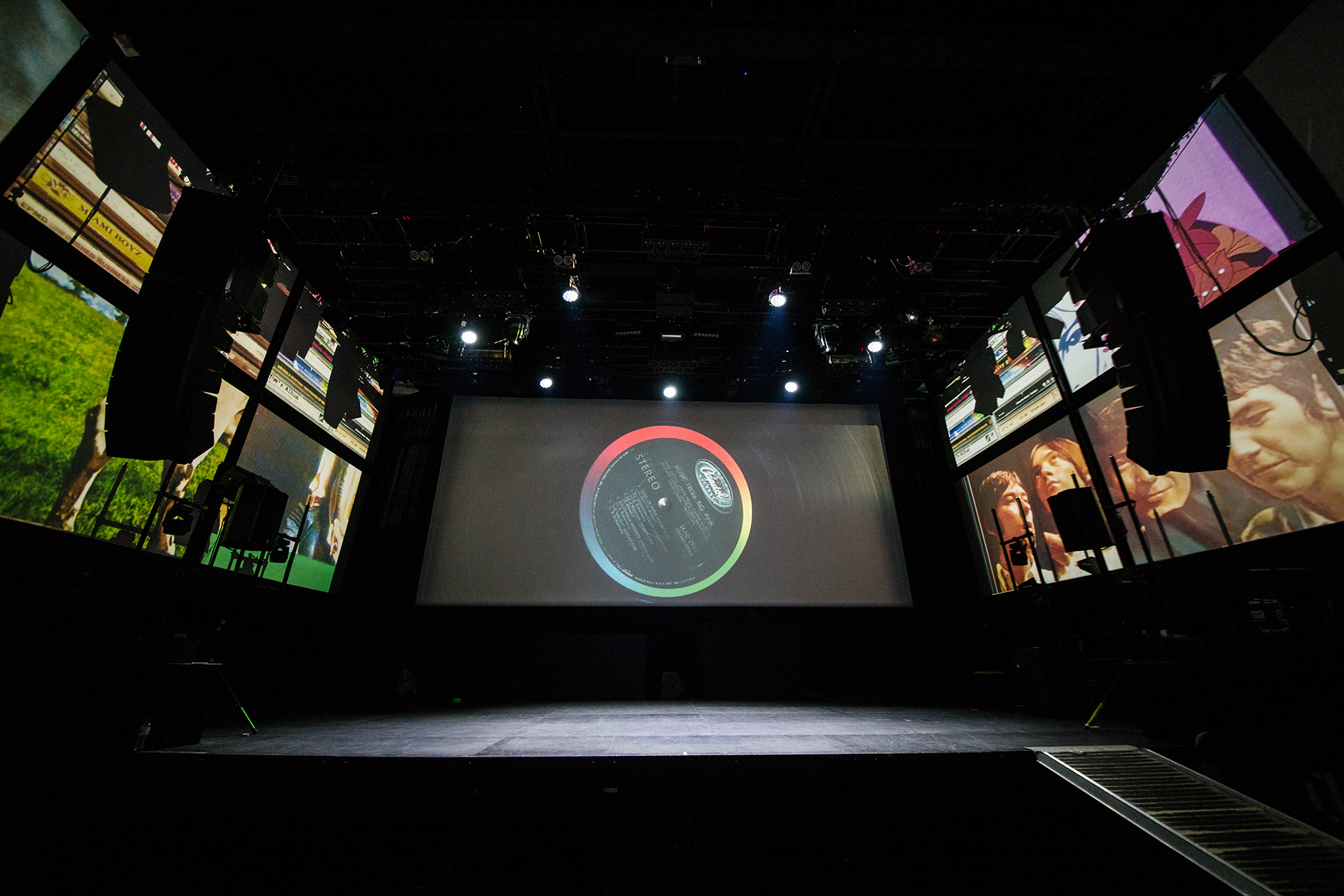 A vinyl record on the central screen, surrounded by music imagery.