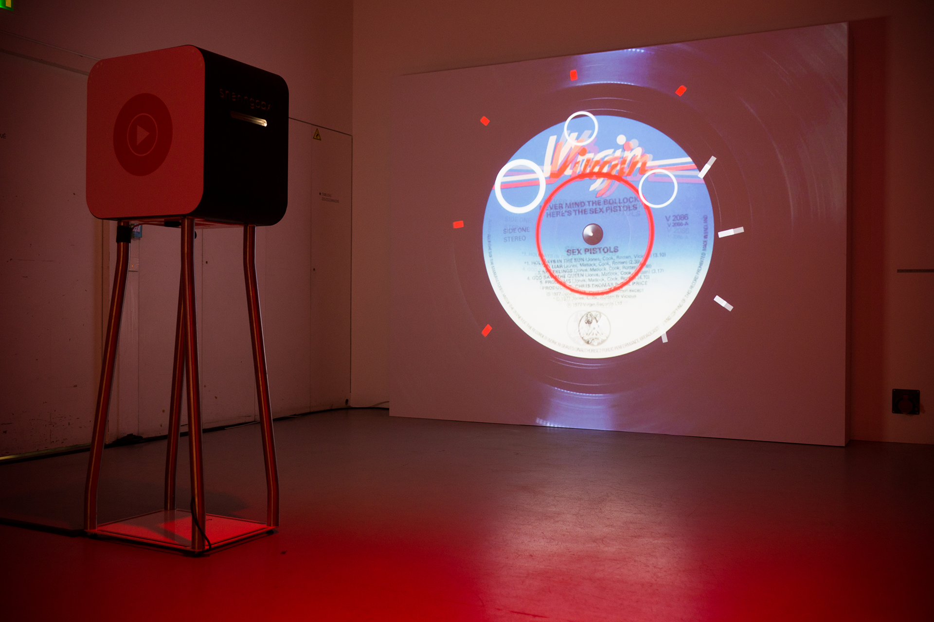 Vinyl-inspired animation projected beside the video booth in the foyer.